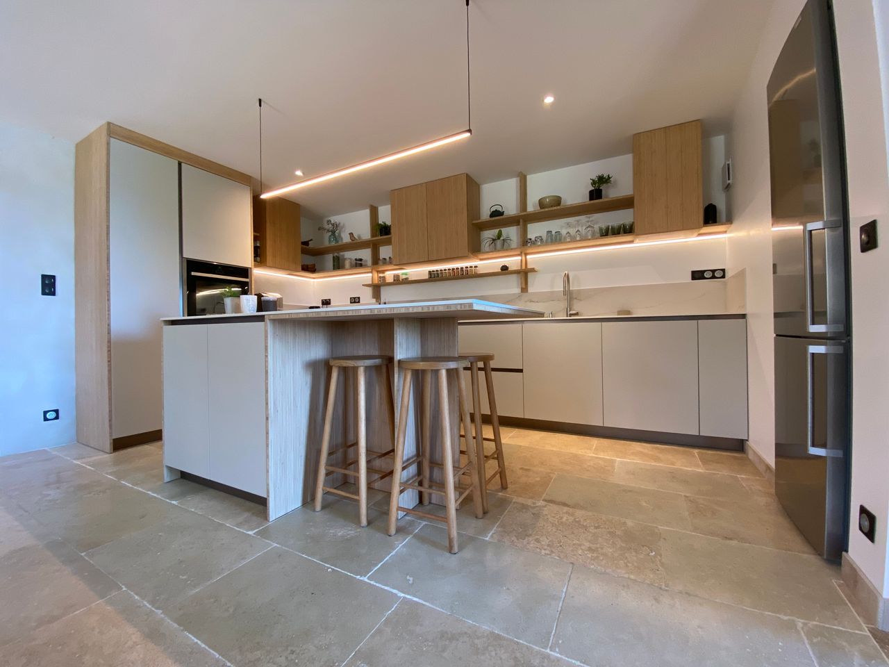 Contemporary kitchen with minimalist design and modern appliances.