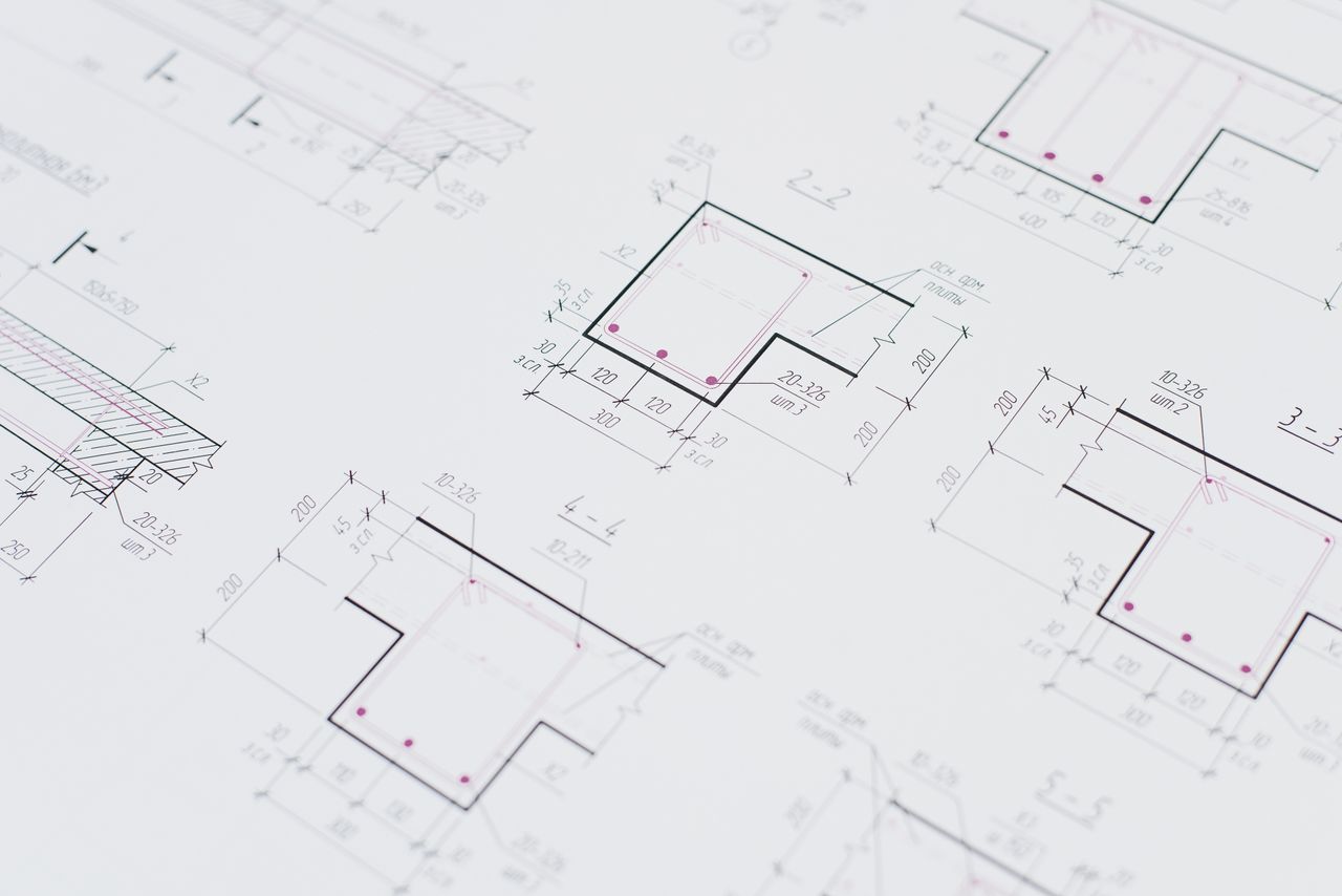 High-resolution close-up of detailed architectural blueprints showcasing precision design layouts.