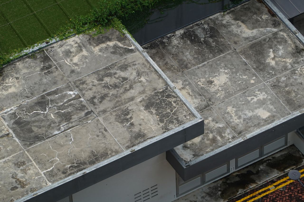 Top-down view of a modern concrete rooftop in Singapore showcasing unique architectural design.