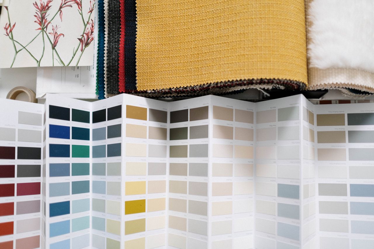 A variety of fabric swatches alongside a detailed color palette for design inspiration.
